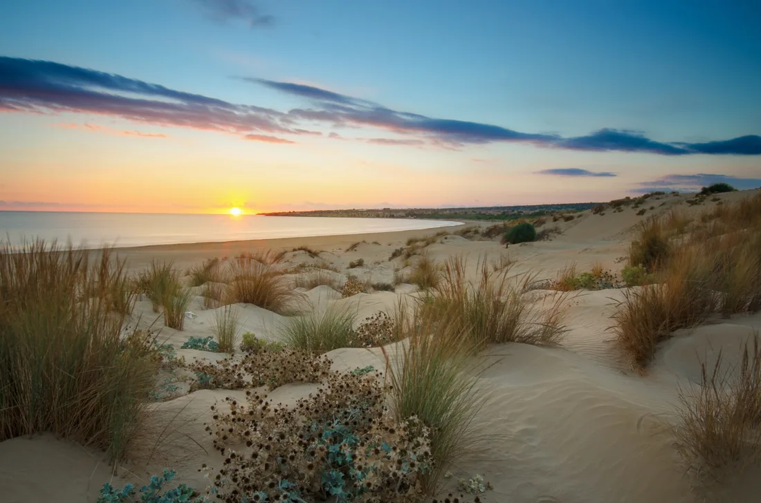 Sunset across dunes and the sea near Sampieri, Sicily.